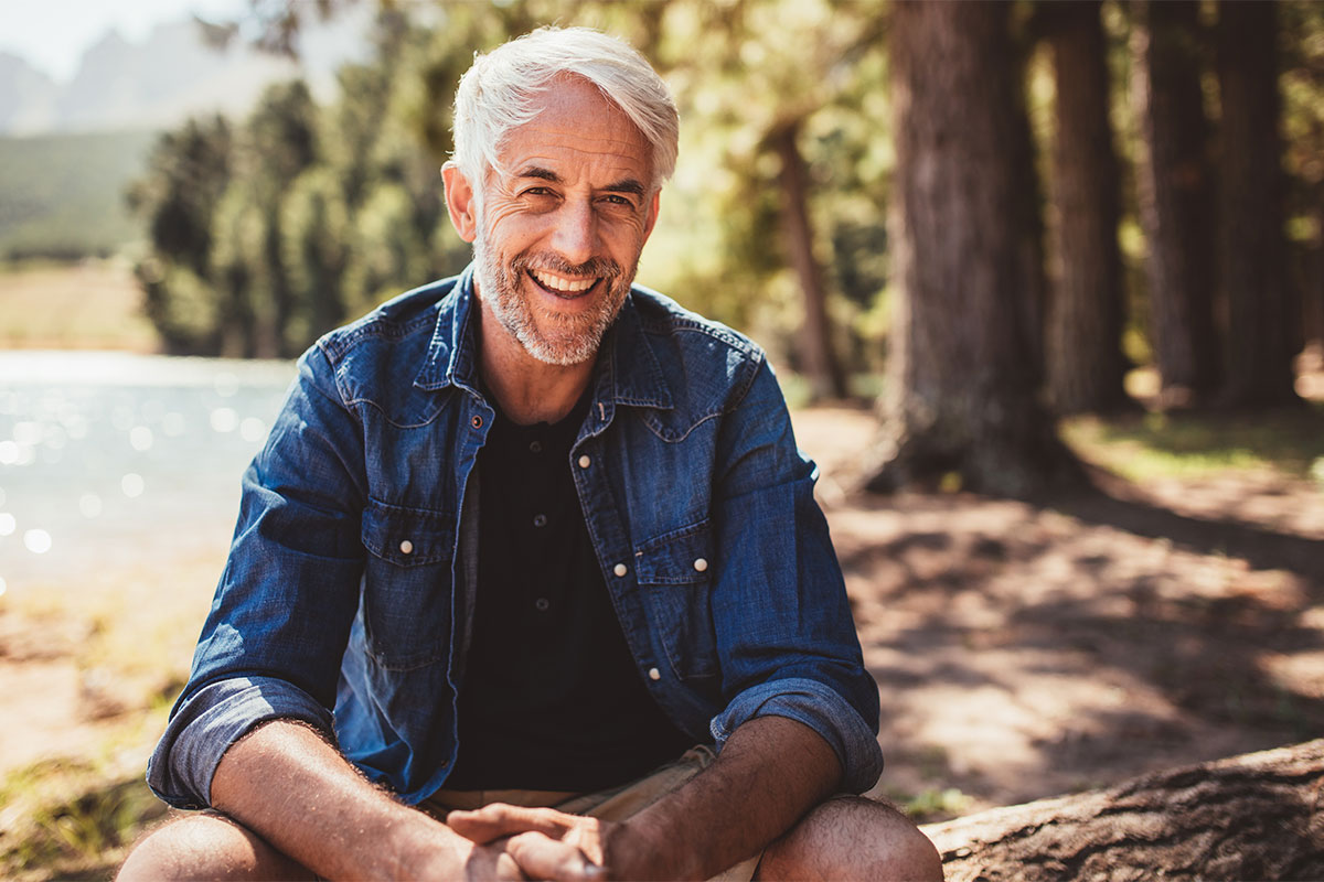 Middle age man smiling outside after treatment for erectile dysfunction in St. John, IN