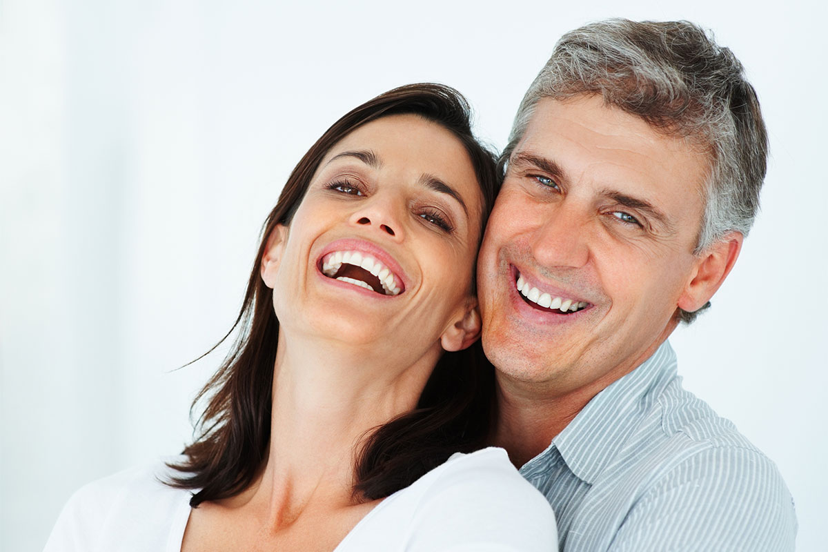 Man and woman laughing after treatment for erectile dysfunction in St. John, IN